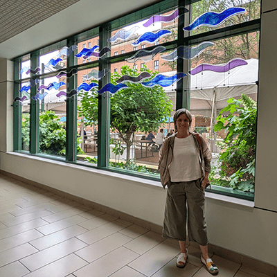 Sandra’s careful placement of the artwork ensures it can be enjoyed during the daytime, and in the evening from the courtyard. The artwork invites people to find a quiet moment for themselves, slowing down and focusing on the colors, shapes, and composition of the sculpture.  