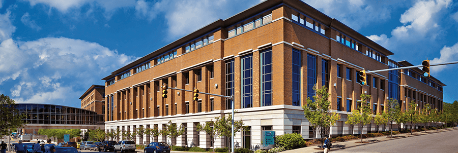 The exterior of UPMC Hillman Cancer Center. The building is a red brick.