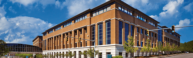 The exterior of UPMC Hillman Cancer Center. The building is a red brick.