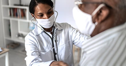 Doctor performing chest exam