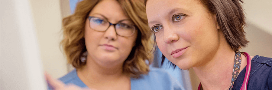 Image of providers looking at monitor.
