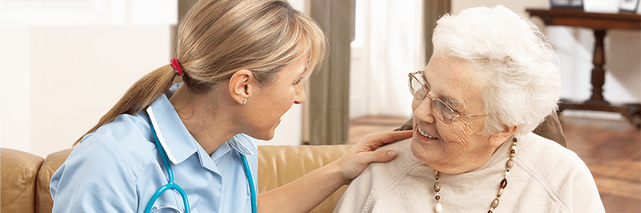 Image of provider talking with older woman.