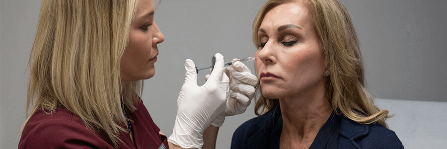 Image of provider injecting botox into patient's face.