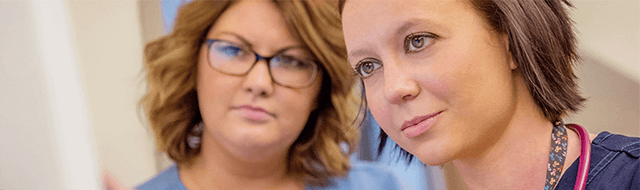 Image of providers looking at chart.