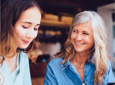 Image of two women talking.