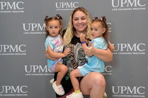 Double the joy – A proud mom and her twins return to celebrate with their NICU family.