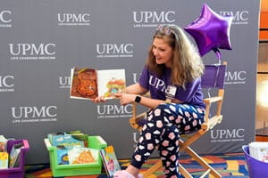 Abby Flanders, executive administrator, Pediatric Service Line, UPMC in Central Pa. reads to the patients during story time.