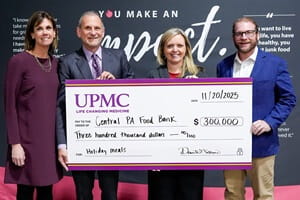 From left to right: Jessica Ritchie, president and chief development officer, UPMC Pinnacle Foundation, and David Gibbons, senior vice president, Health Services Division, and regional president, UPMC, present a check for $300,000 to Shila Ulrich, chief executive officer, Central Pennsylvania Food Bank, and Matt Lane, senior vice president and chief development officer, Central Pennsylvania Food Bank. 