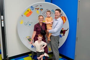 A family pose at one of the exhibits during the NICU Reunion Pajama Party at the Whitaker Center in Harrisburg.