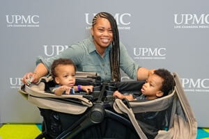 A proud mother and her twins enjoy an evening of celebration and reconnection with their NICU family.