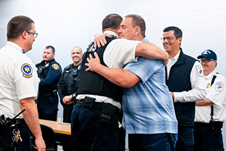 Bill embraces Alex Karney, paramedic, Susquehanna Regional EMS, as he presents him with his “SCA Save” commendation bar.