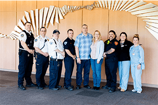 Bill Gusler, pictured center, poses with the team of responders and clinicians who helped save his life after he suffered a sudden cardiac arrest in Williamsport.