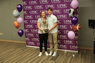 Chelsea Rieppel and SAPA recipient Benjamin Manning, South Williamsport Jr./Sr. High School, accept the Champions Cup for the Small Division title.