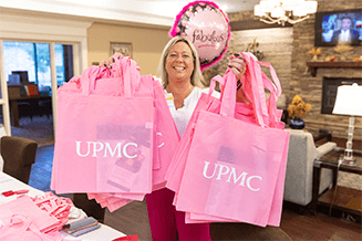 Jennifer Easton, enrollment navigator, UPMC in North Central Pa., shows off Pretty in Pink bags full of resources and information on UPMC Women’s Health services. 