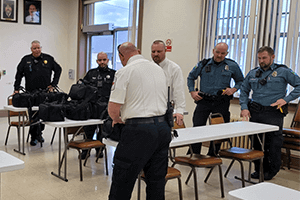 Jason Kling, paramedic platoon chief, Susquehanna Regional EMS, explains the contents of the donated medical bags to members of Lock Haven Police and the Clinton County Sheriff’s Office.