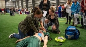 Students perform CPR on a dummy at the UPMC High School Career Expo at the Liberty Arena.