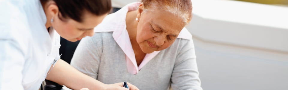 Woman reviewing medical bills with professional.