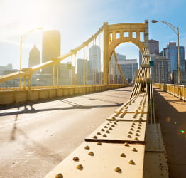 A bridge in Pittsburgh, Pa. with the city skyline in the background.