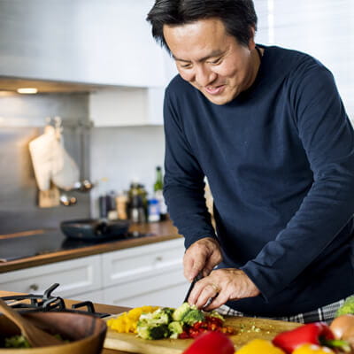 Image of man slicing vegetables.