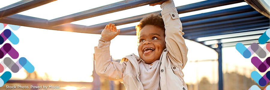 Child and adolescent banner. Image of child playing on jungle gym.