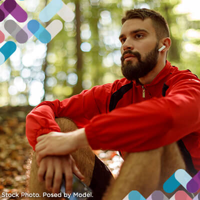 Adult Services Callout. Image of man sitting in woods.