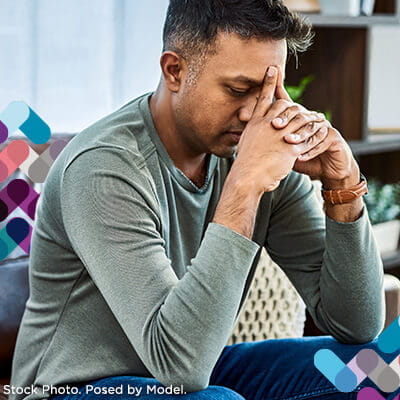 Emergency services callout. Image of man holding his head.
