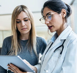 Doctor reviews chart with patient