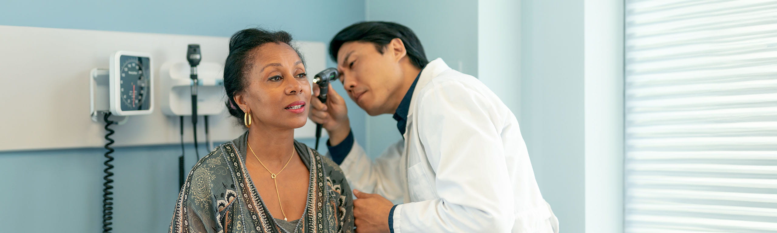 Image of doctor looking in patient's ear.