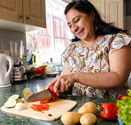Woman cuts vegetables