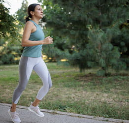 Woman jogging through park