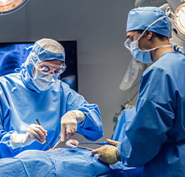 Two surgeons operating on patient