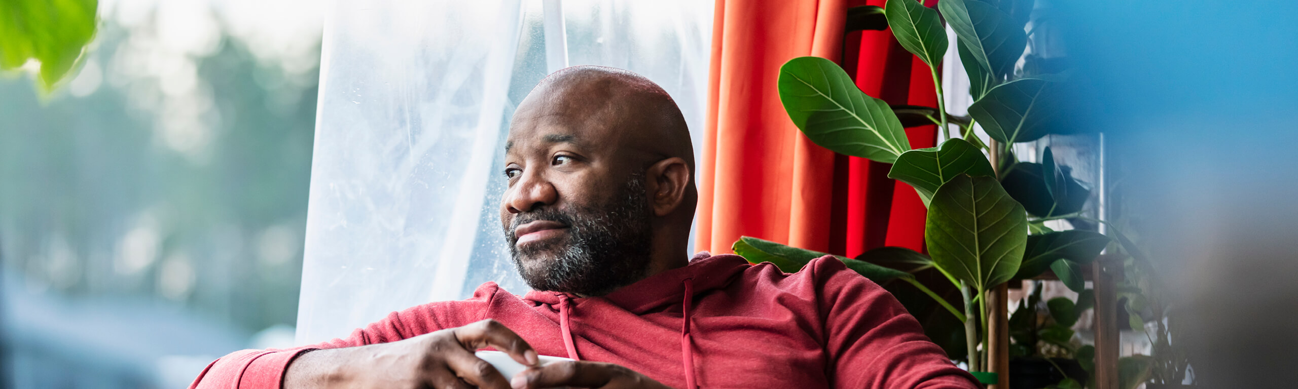 Image of man looking out window.