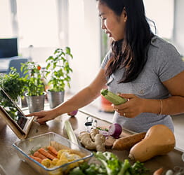 Woman reading recipe and cooking