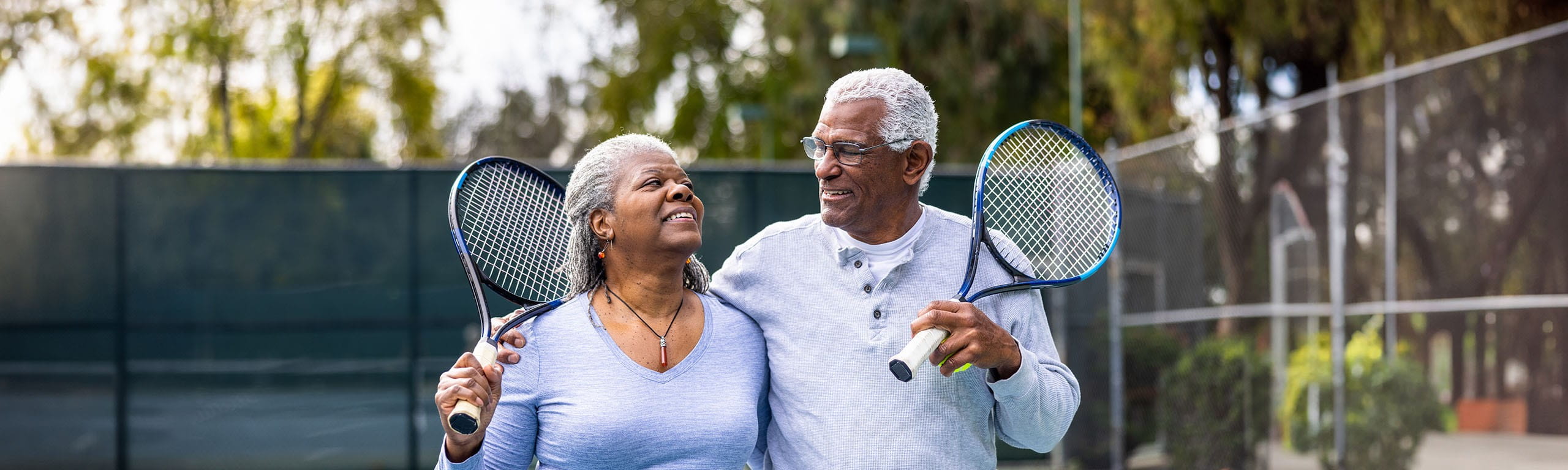 Photo of a couple playing tennis.