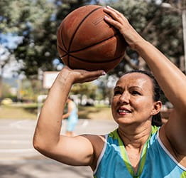 Woman shooting a basketball.