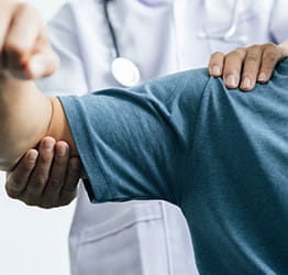 Doctor checking a patients arm.