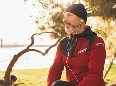 Man outside preparing to run