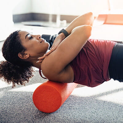 Spine surgery image card -- woman stretching back.