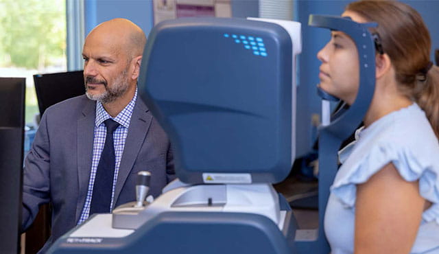 Doctor diagnosing a patient's type of concussion using VOMS technology.