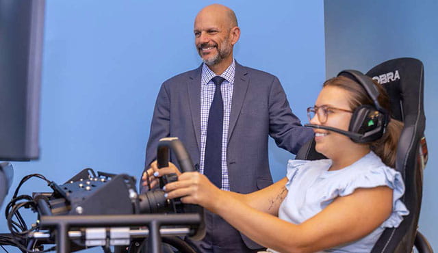 Patient using a driving simulator during concussion treatment. 