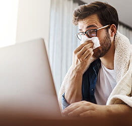 Male patient users computer for virtual primary care visit