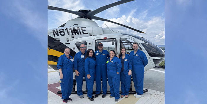 Pediatric transport team in front of a helicopter