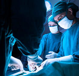 Surgeons work on patient in operating room