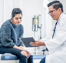 Doctor shows patient her medical chart