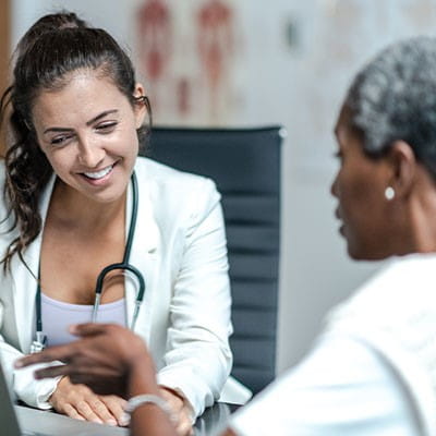 Photo of a doctor talking to a patient.