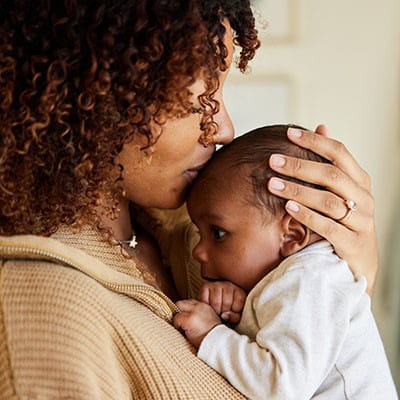 Photo of a woman holding a baby.