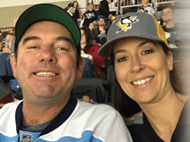 Code wears a sports jersey and a baseball cap. He is smiling.