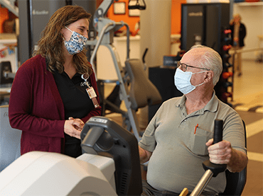 Jerry works on an upper arm bicycle machine as part of his physical therapy.