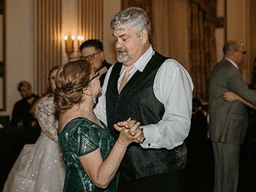 Image of Matthew dancing with his wife at a wedding.