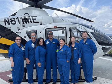 Pediatric transport team in front of a helicopter